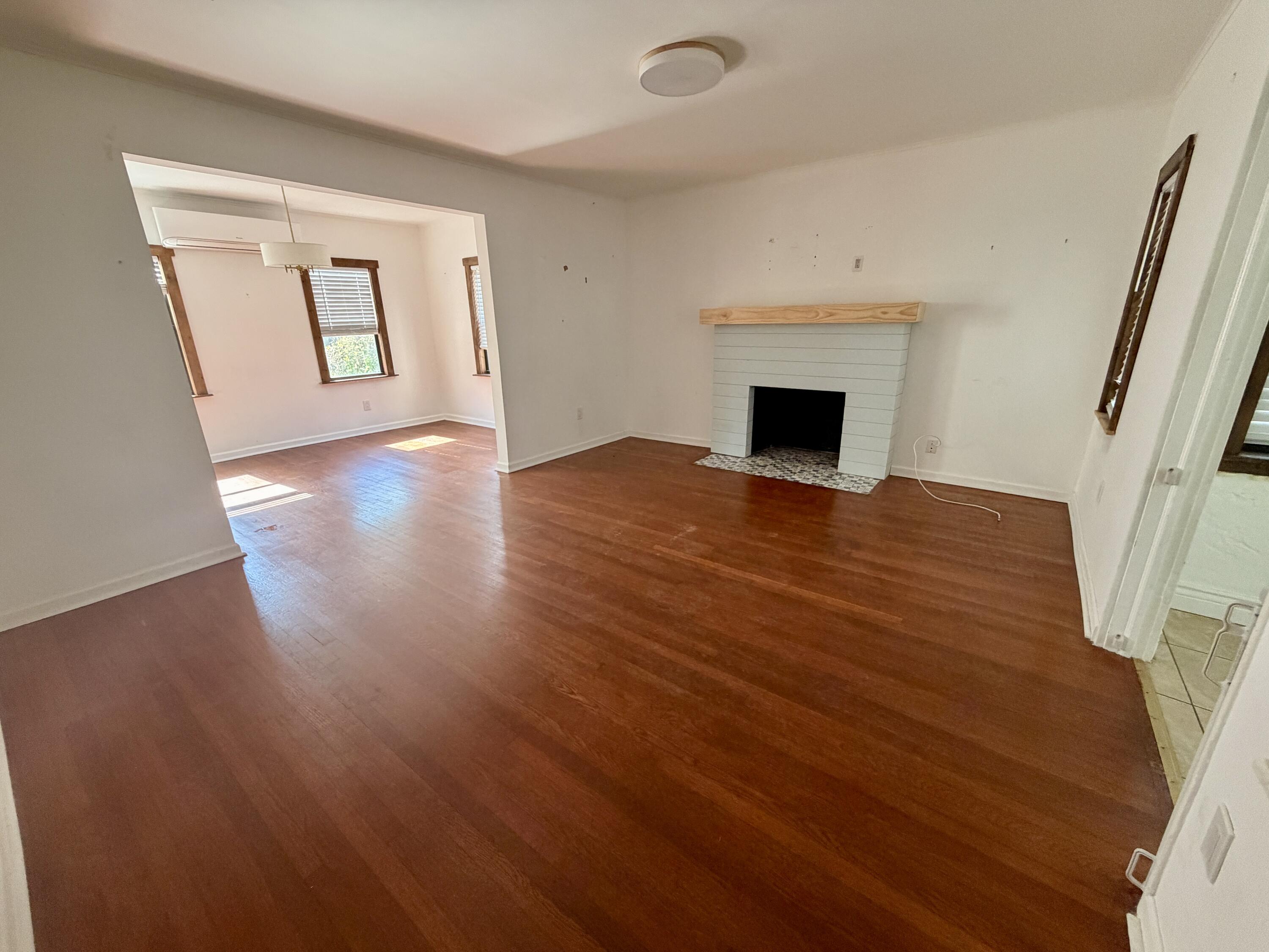 1026 Upland Road, Unit MAIN HOUSE West Palm Beach, FL 33401 - Photo 5 of 11 an empty room with wooden floor and fireplace