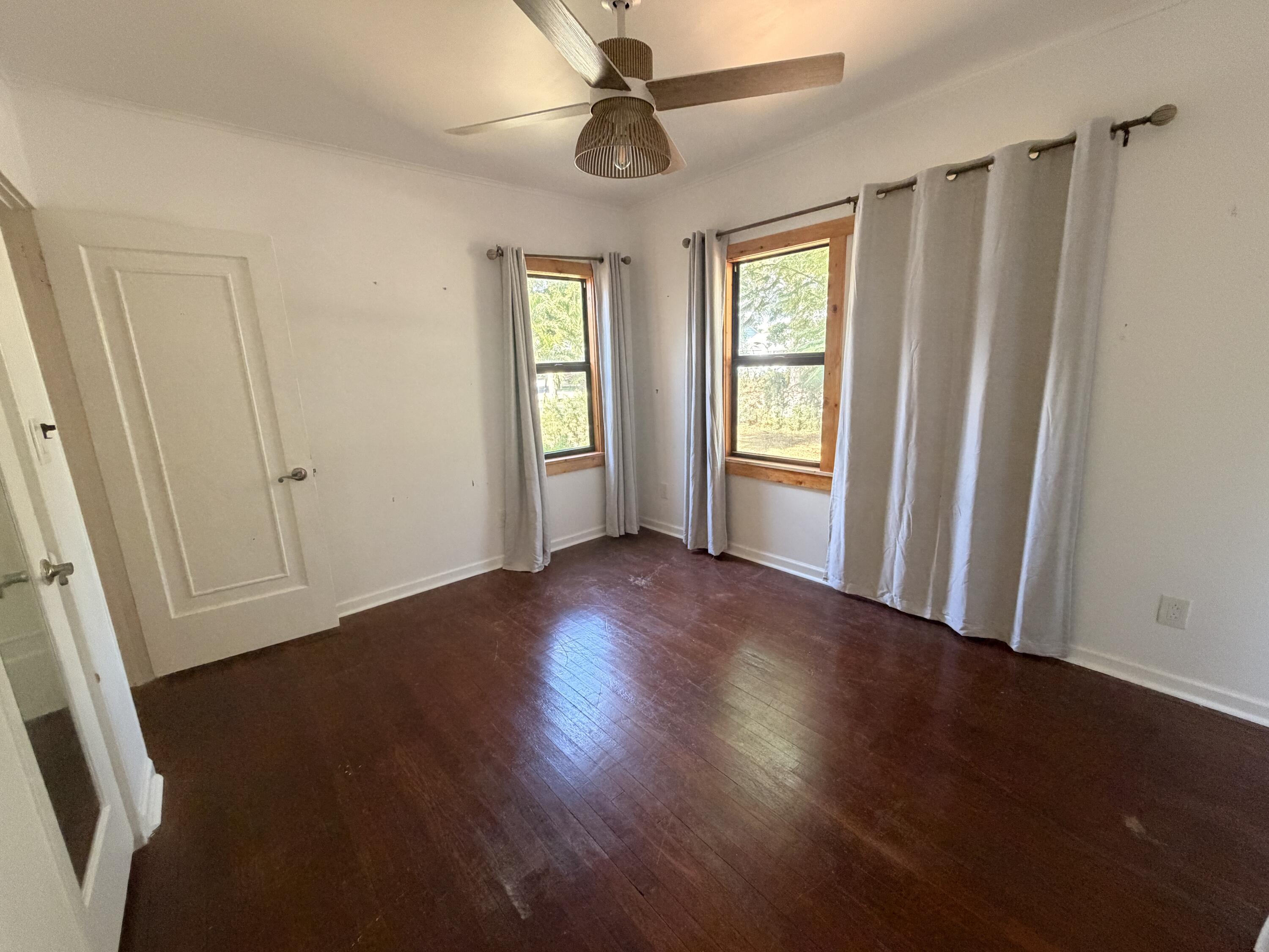 1026 Upland Road, Unit MAIN HOUSE West Palm Beach, FL 33401 - Photo 8 of 11 a view of empty room with wooden floor and fan