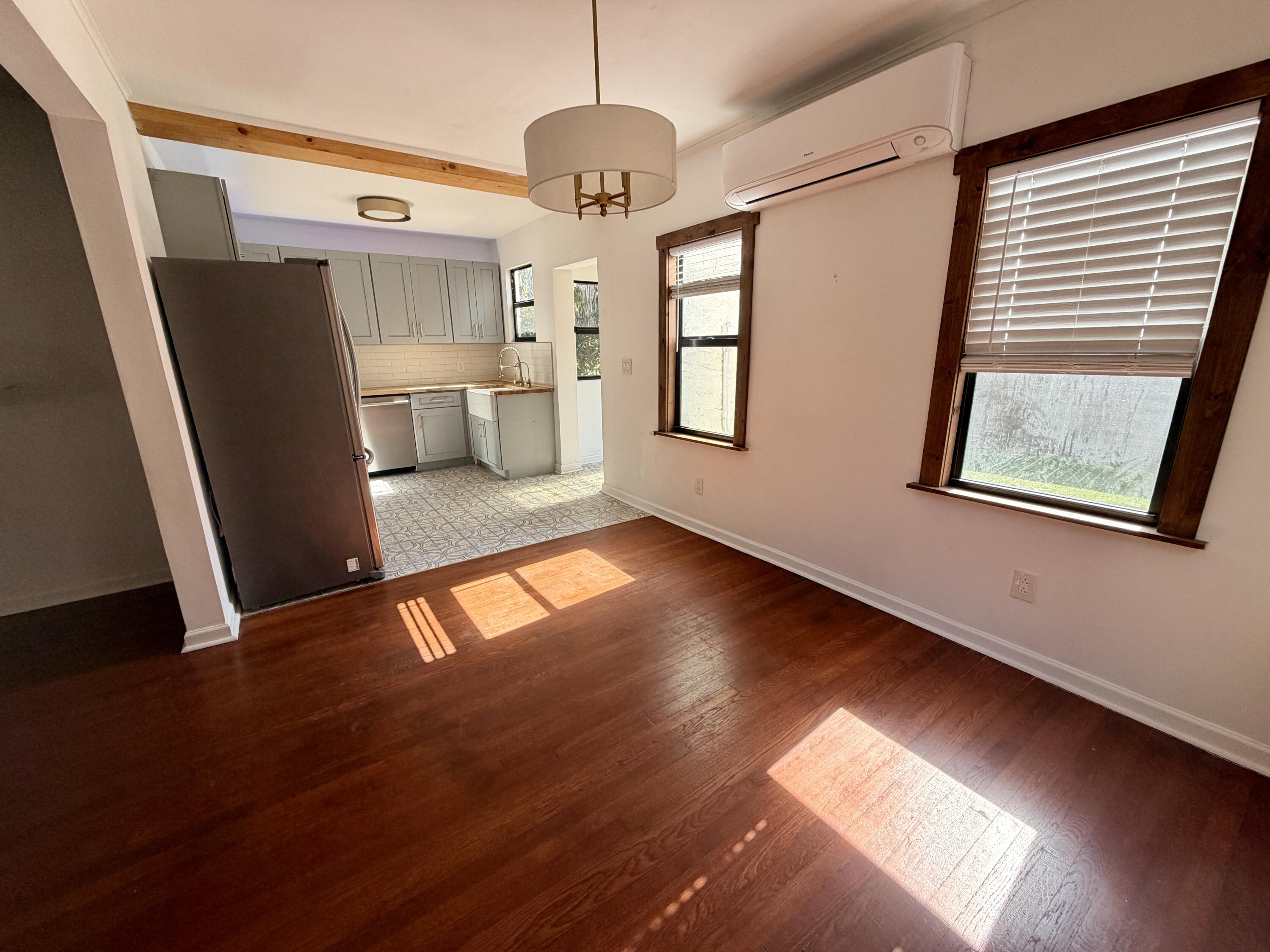 1026 Upland Road, Unit MAIN HOUSE West Palm Beach, FL 33401 - Photo 10 of 11 a view of a living room with a hardwood floor and a ceiling fan