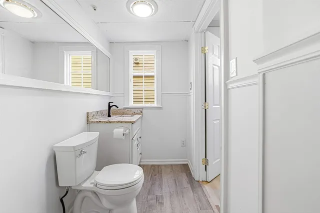 a bathroom with a toilet a sink and a window