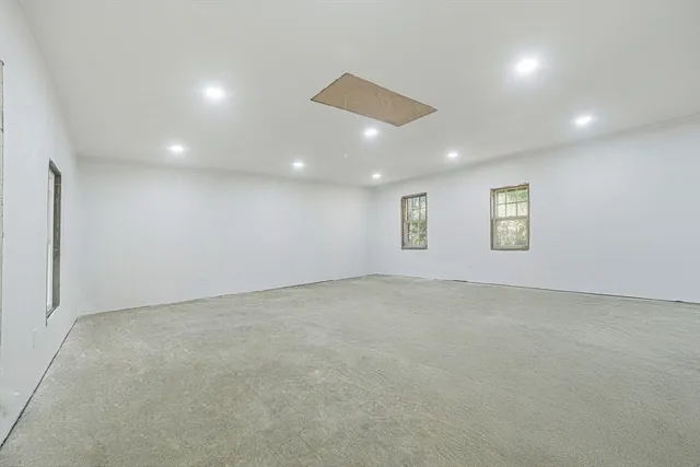 an empty room with a empty space and windows