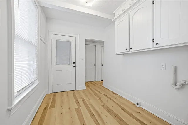 a view of a room with wooden floor and cabinet