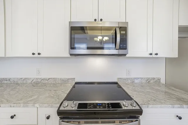 a stove top oven sitting inside of a kitchen