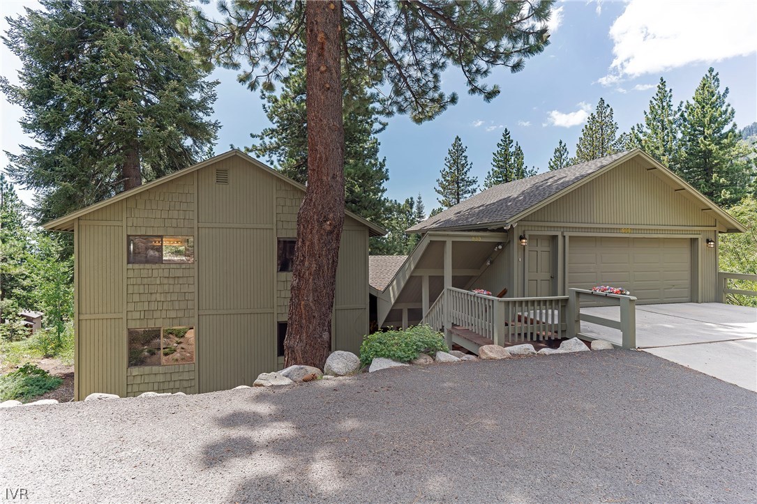 999 Apollo Way Incline Village, NV 89451 - Photo 27 of 33 a view of a house with a small yard and a large tree