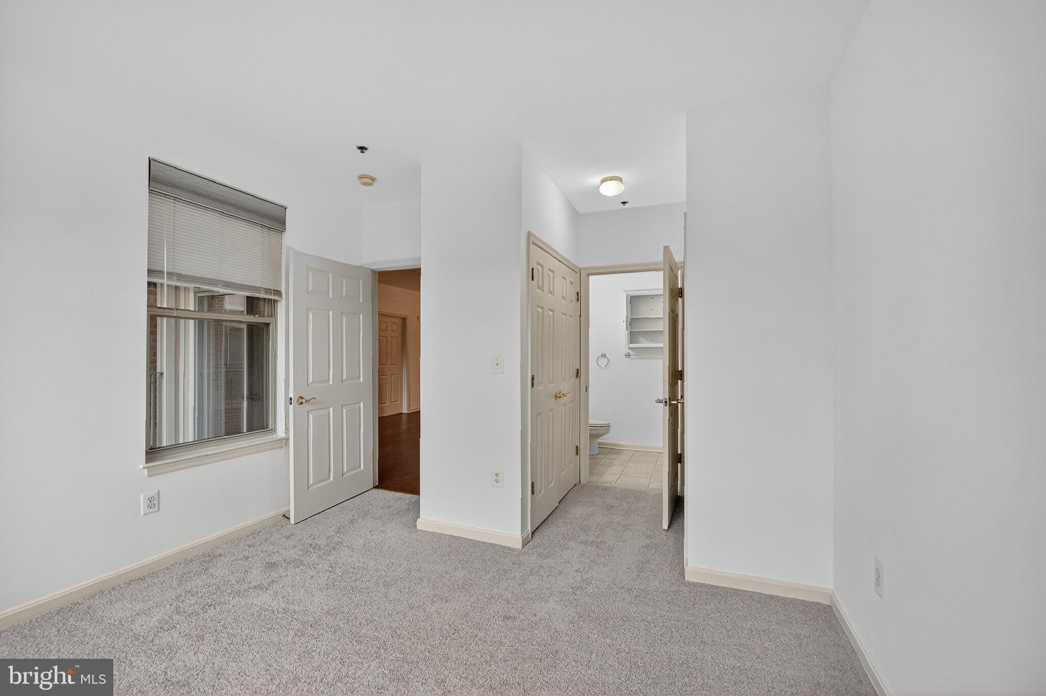 11775 Stratford House Place, Unit 206 Reston, VA 20190 - Photo 22 of 39 a view of an empty room with closet and a window
