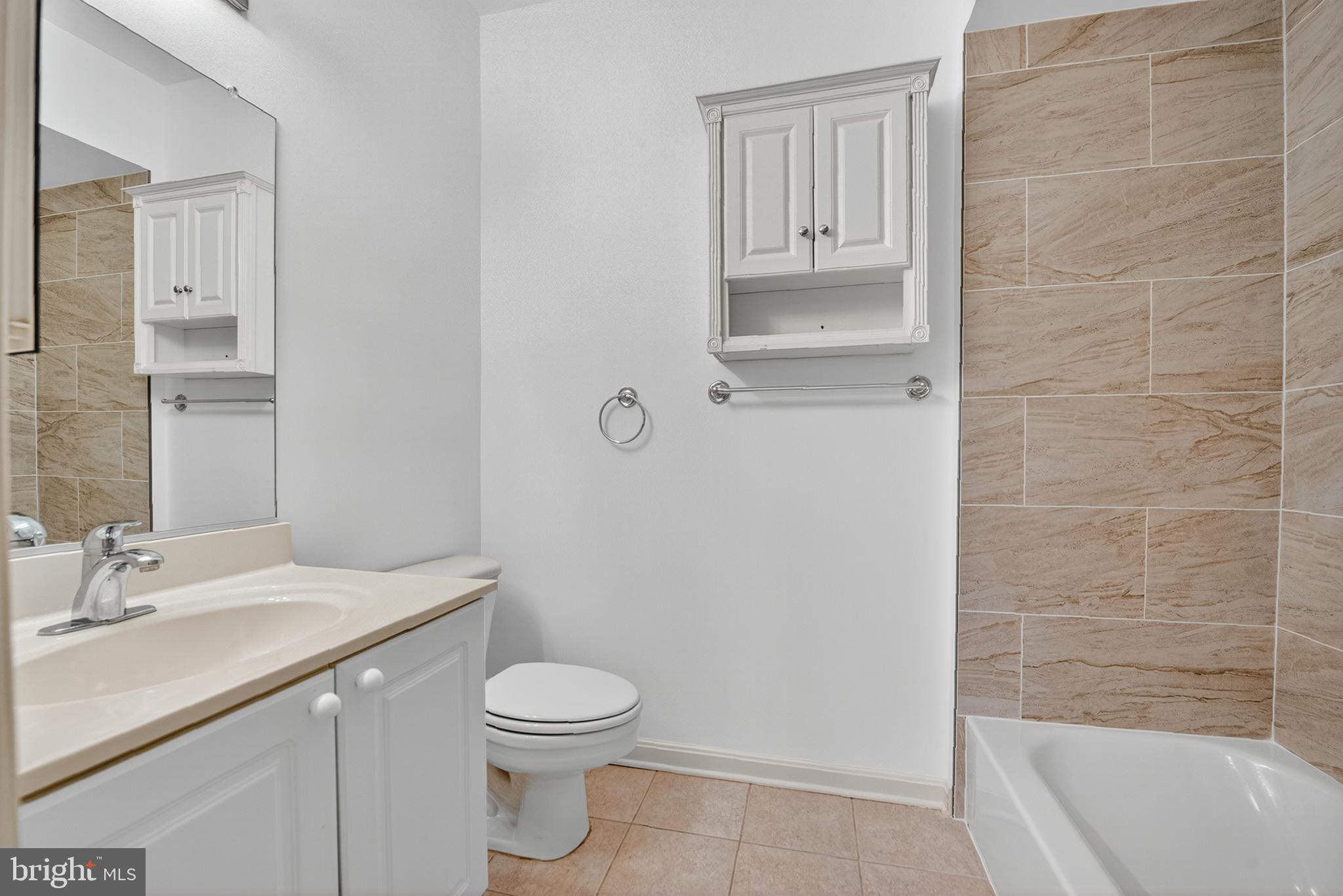 11775 Stratford House Place, Unit 206 Reston, VA 20190 - Photo 23 of 39 a bathroom with a sink a toilet and shower