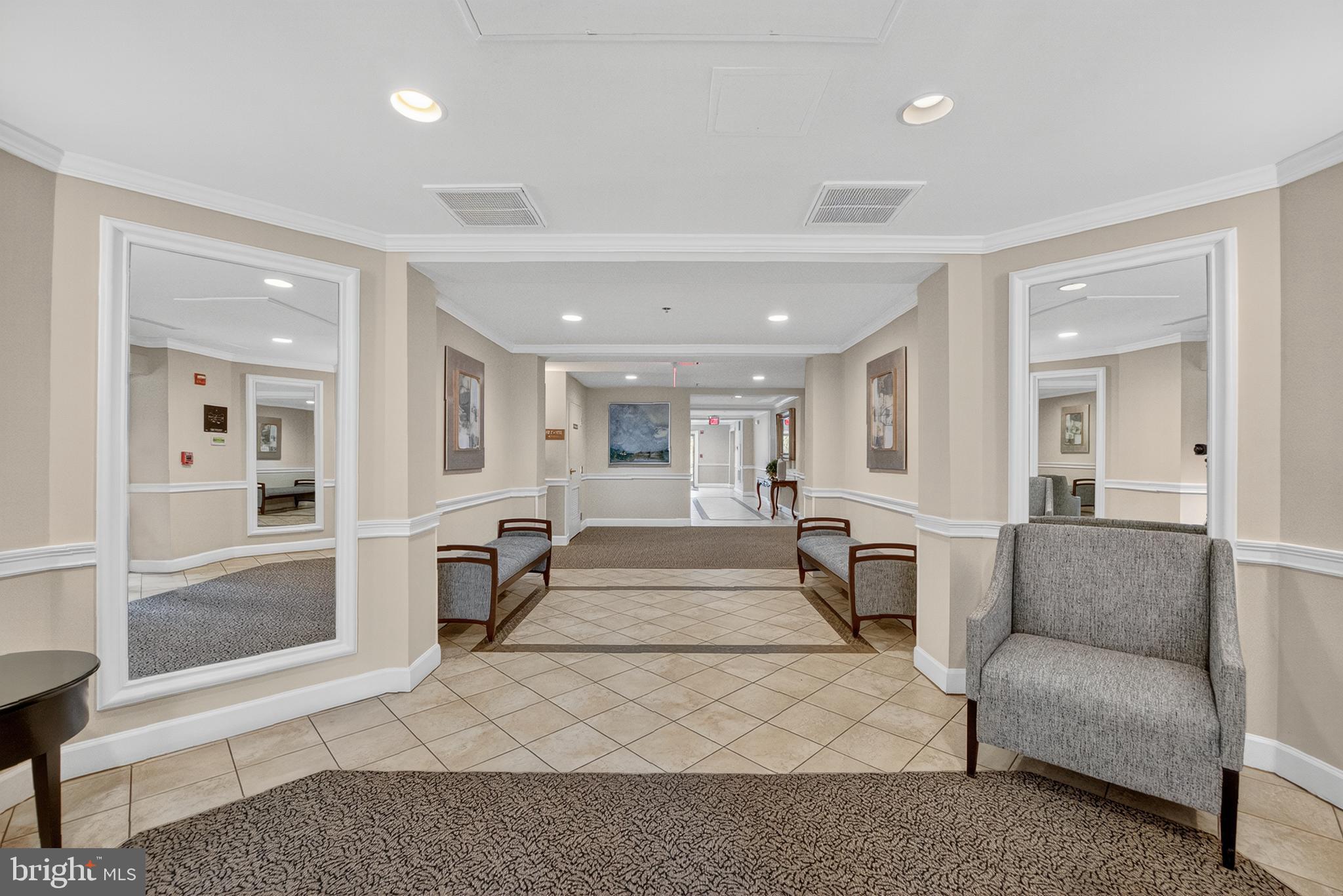 11775 Stratford House Place, Unit 206 Reston, VA 20190 - Photo 26 of 39 a living room with furniture and a rug