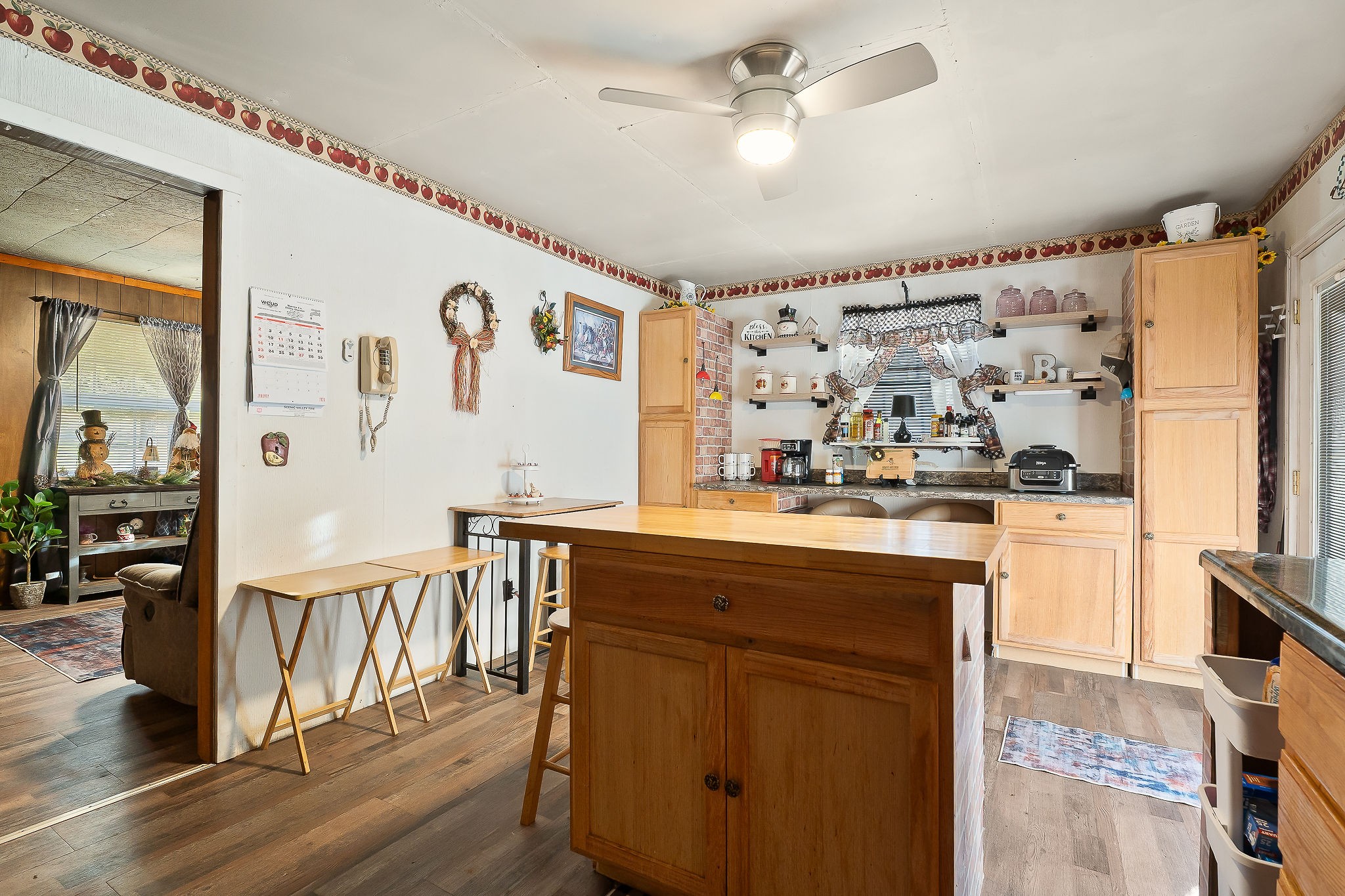 968 Boyd Road Rock Island, TN 38581 - Photo 7 of 42 a kitchen with stainless steel appliances granite countertop a refrigerator a sink dishwasher and white cabinets with wooden floor