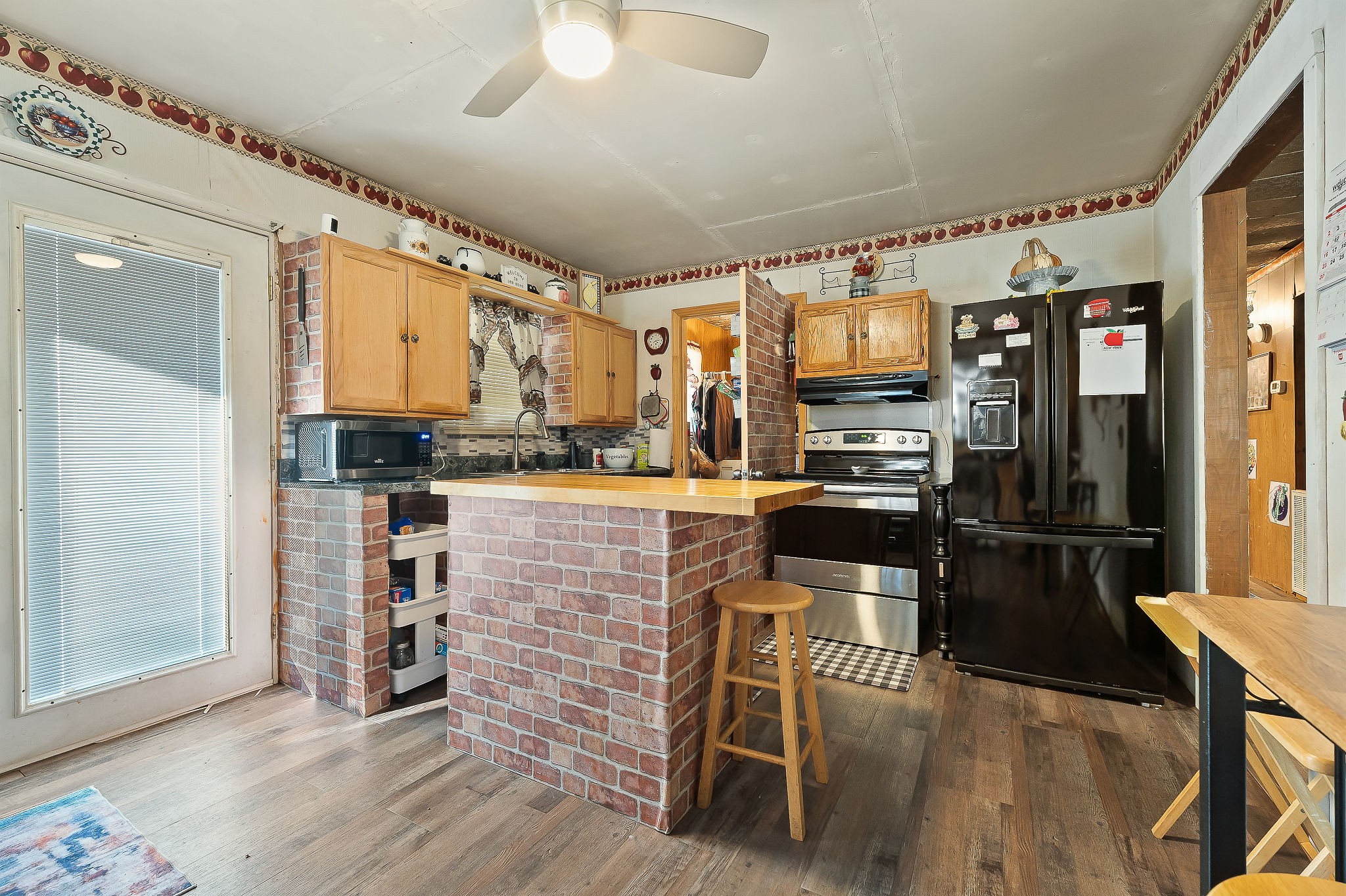 968 Boyd Road Rock Island, TN 38581 - Photo 9 of 42 a kitchen with stainless steel appliances kitchen island granite countertop a refrigerator a stove a sink and white cabinets with wooden floor