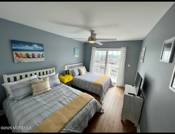 a bedroom with two beds and a large window
