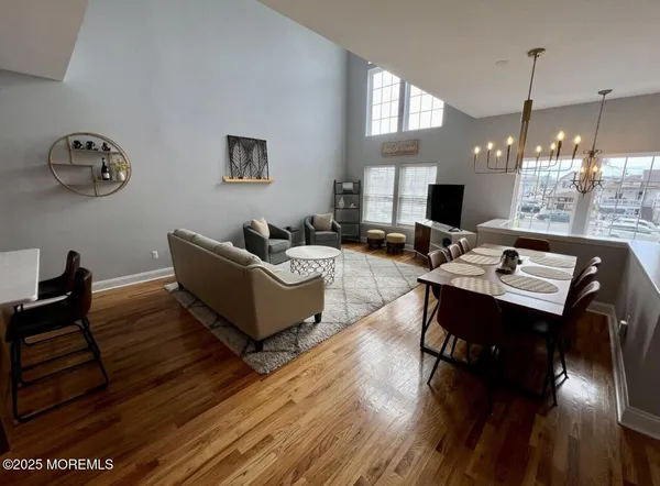 a living room with furniture dining table and a wooden floor