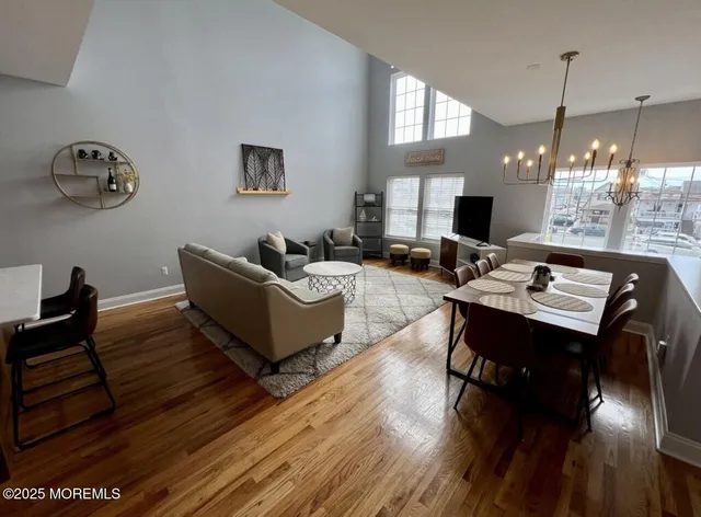 a living room with furniture dining table and a wooden floor