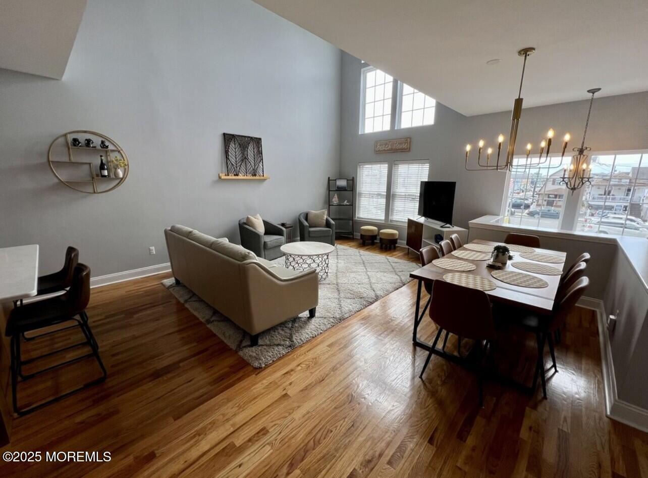 15 Sumner Avenue, Unit 11 Seaside Heights, NJ 08751 - Photo 4 of 13 a living room with furniture dining table and a wooden floor