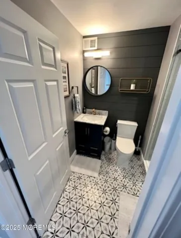 a living room with furniture and a mirror