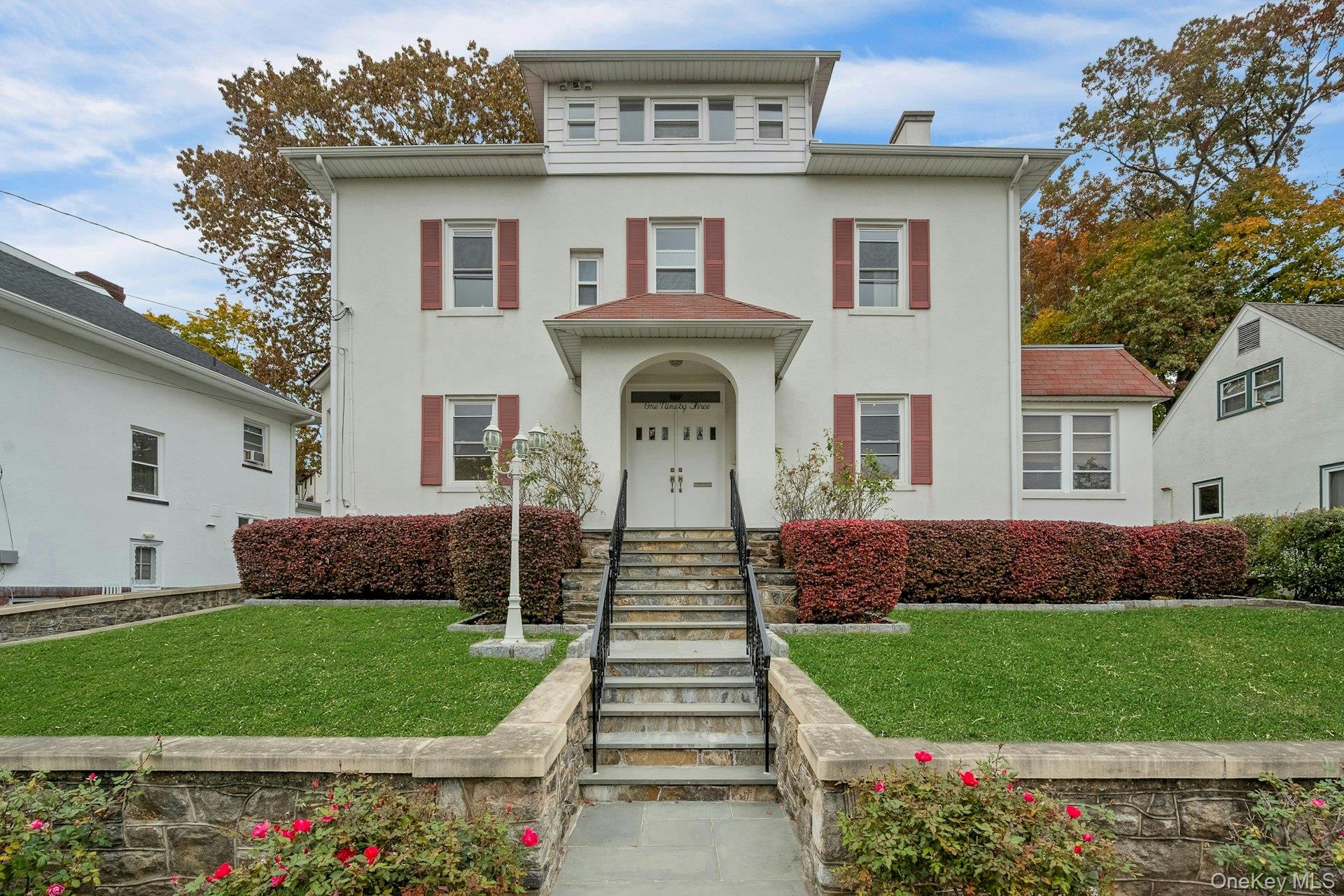 a front view of a house with a garden