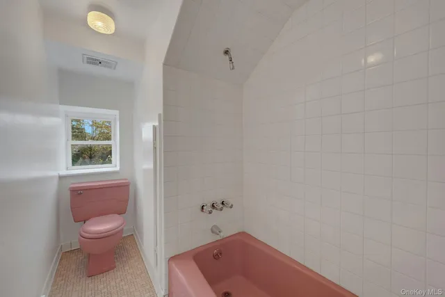 a room with pool table and windows