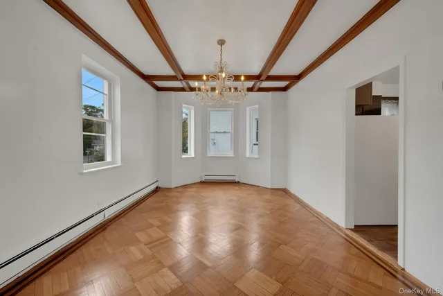 a view of hallway with stairs and a window