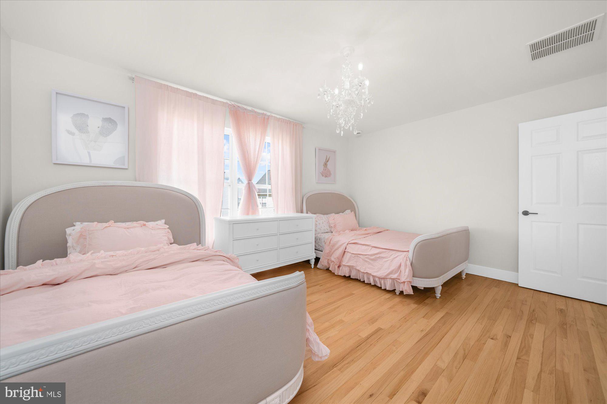 86 Treetops Circle Princeton, NJ 08540 - Photo 26 of 41 a bedroom with a bed and wooden floor