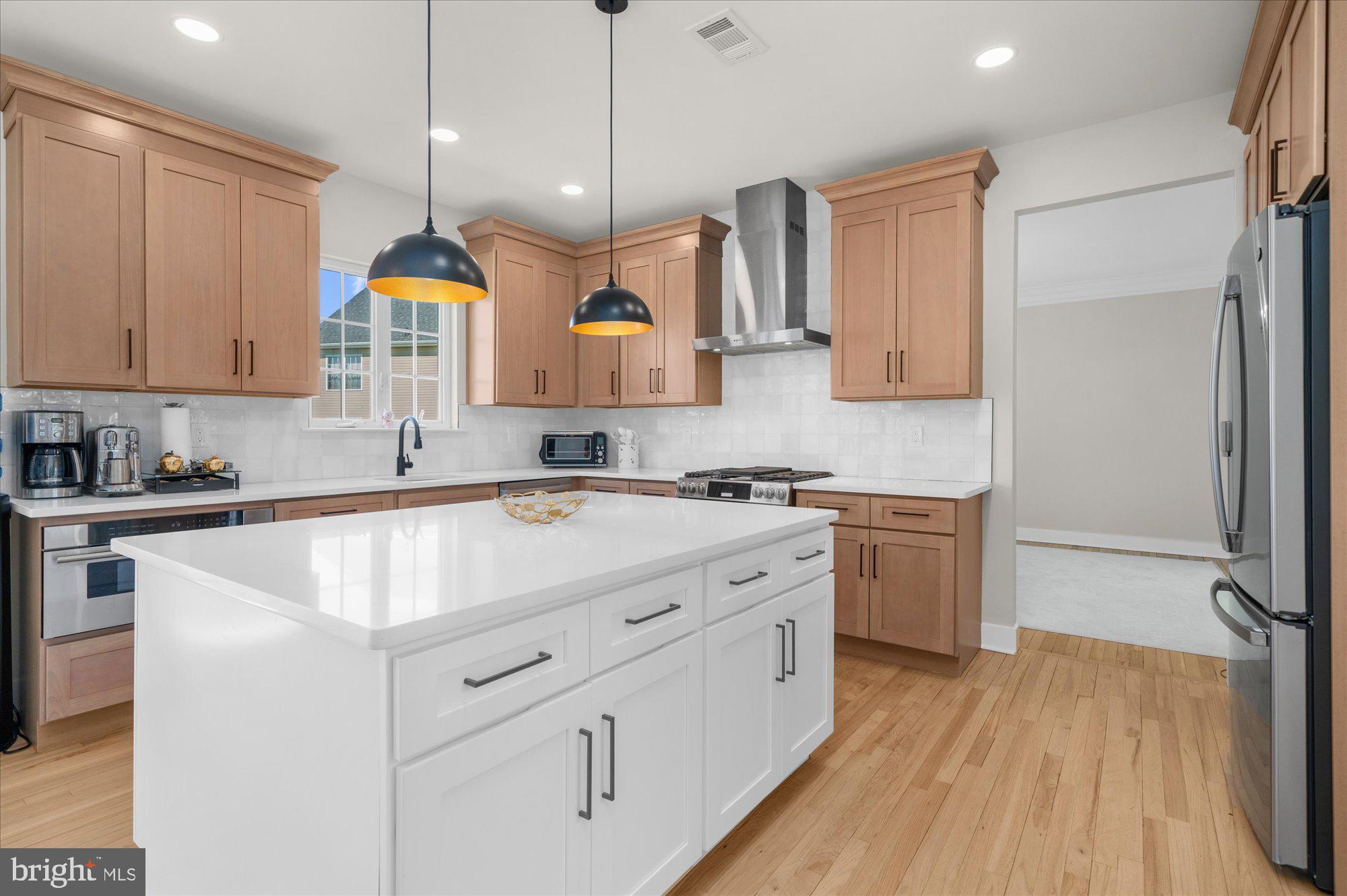 86 Treetops Circle Princeton, NJ 08540 - Photo 7 of 41 a kitchen with stainless steel appliances granite countertop a sink a stove and a wooden floors