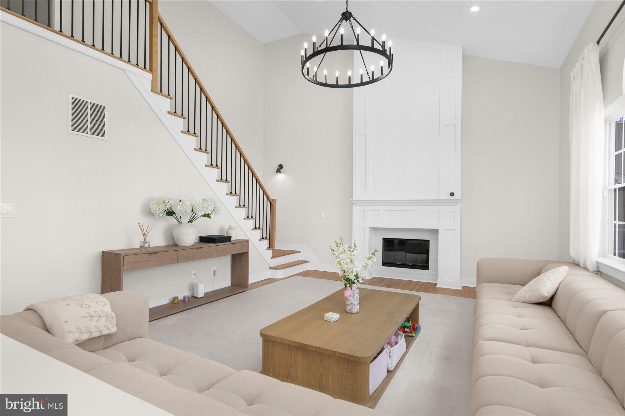 86 Treetops Circle Princeton, NJ 08540 - Photo 10 of 41 a living room with furniture a chandelier and a fireplace