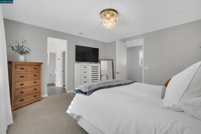 a bathroom with a double vanity sink a mirror and a bathtub