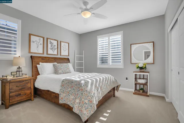 a view of a patio with table and chairs under an umbrella with a small yard