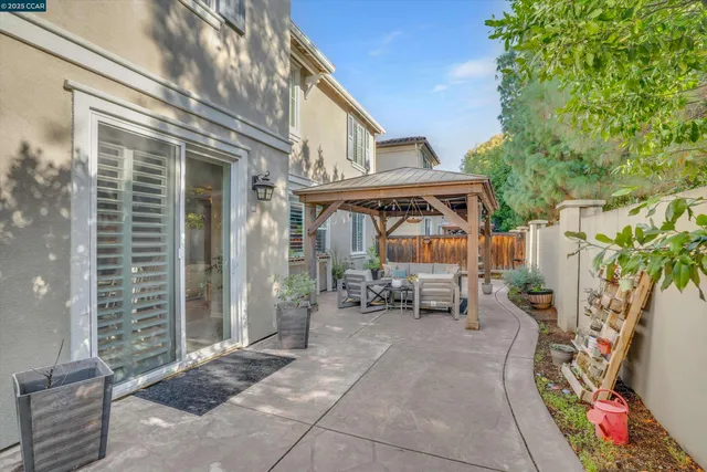 a view of a patio with a table and chairs and potted plants