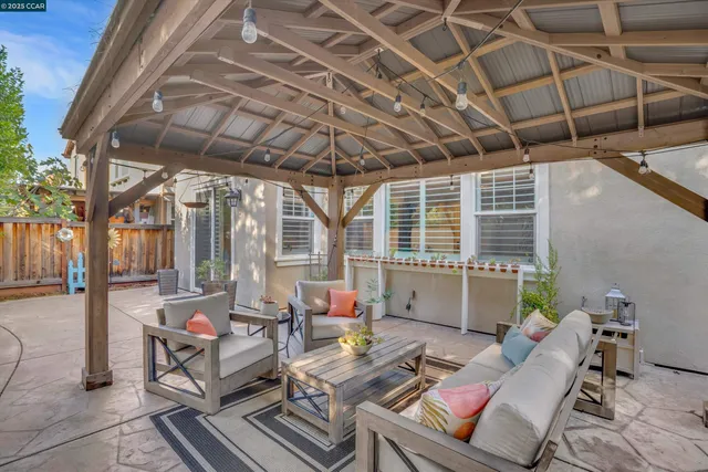 a view of living room filled with furniture and potted plants