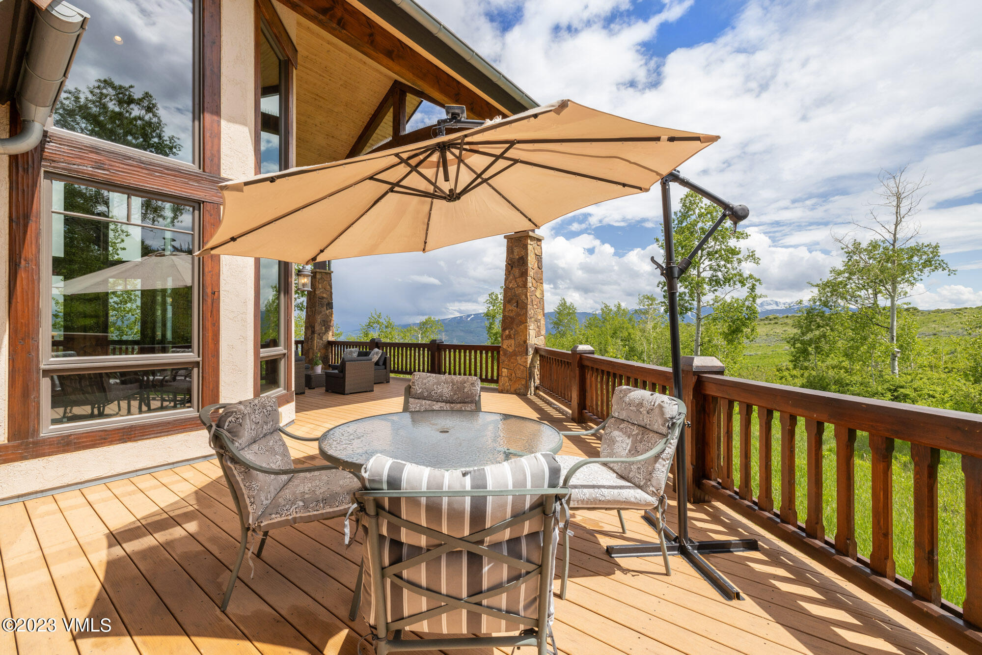 5458 Bellyache Ridge Road Wolcott, CO 81655 - Photo 54 of 63 a view of a patio with table and chairs under an umbrella