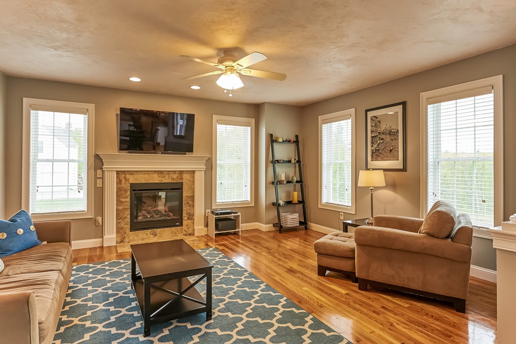 13 West Ledge Road Clinton, MA 01510 - Photo 13 of 30 a living room with furniture a flat screen tv and a fireplace
