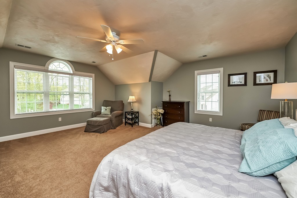 13 West Ledge Road Clinton, MA 01510 - Photo 17 of 30 a spacious bedroom with a bed a large window with table and chair