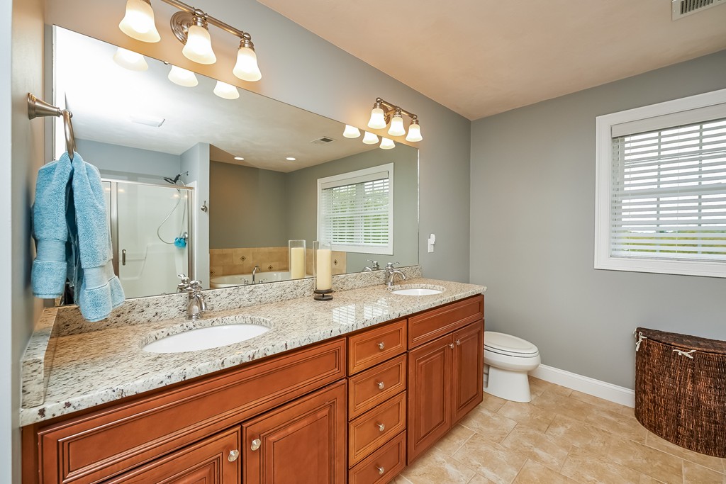 13 West Ledge Road Clinton, MA 01510 - Photo 18 of 30 a bathroom with a granite countertop double vanity sink a toilet and a mirror