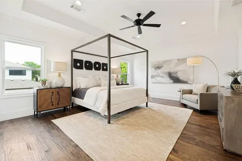 a bedroom with a large bed and a chandelier