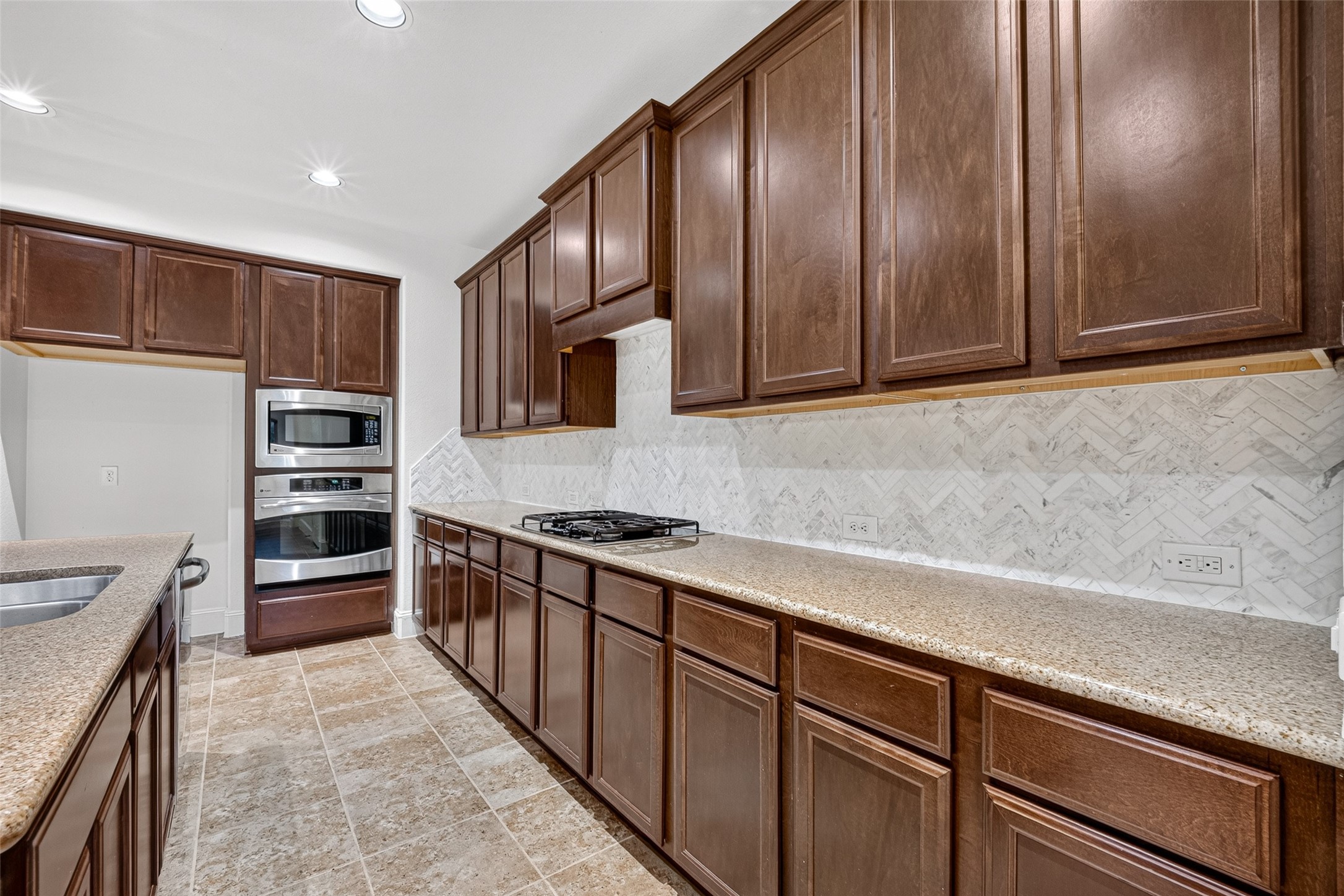 7930 Summer Night Lane Rosenberg, TX 77469 - Photo 15 of 48 Well-appointed kitchen with extensive cabinetry, built-in appliances, and abundant countertop space.
