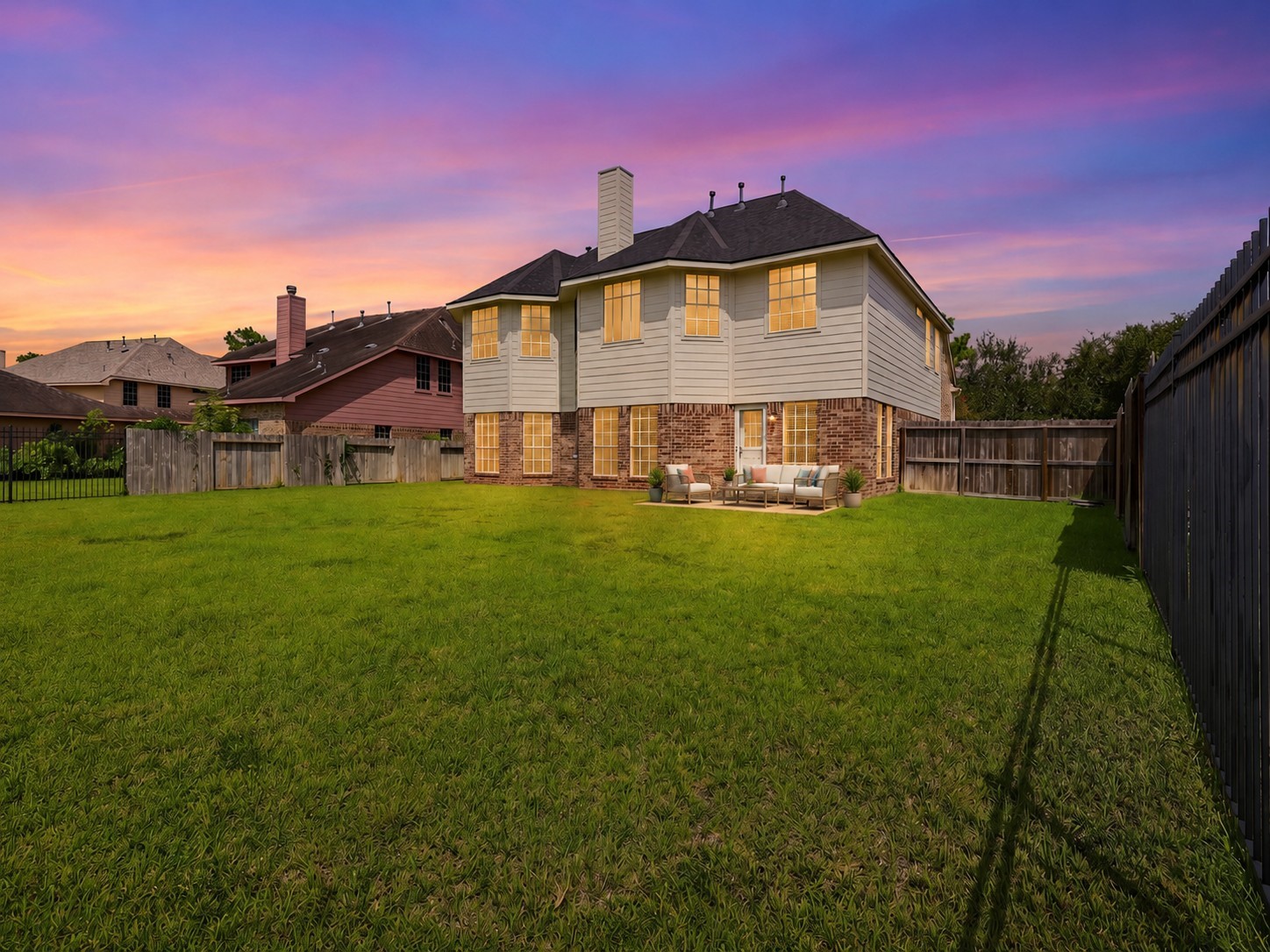13806 Cove Landing Lane Rosharon, TX 77583 - Photo 37 of 44 Twilight views highlight the home’s rear elevation, expansive yard, and warm exterior lighting.**Virtually staged