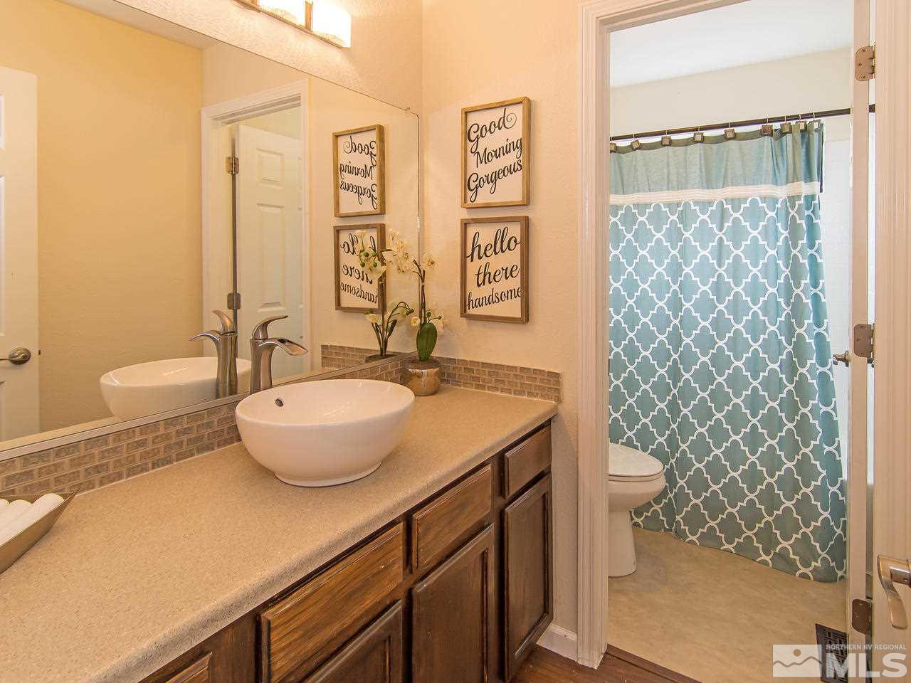 5302 Vista Ridge Way Reno, NV 89523 - Photo 11 of 20 a bathroom with a sink a toilet and shower curtain