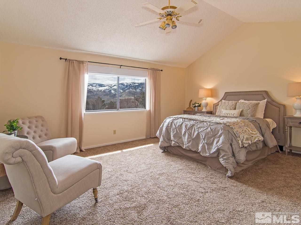 5302 Vista Ridge Way Reno, NV 89523 - Photo 13 of 20 a spacious bedroom with a bed and a couch