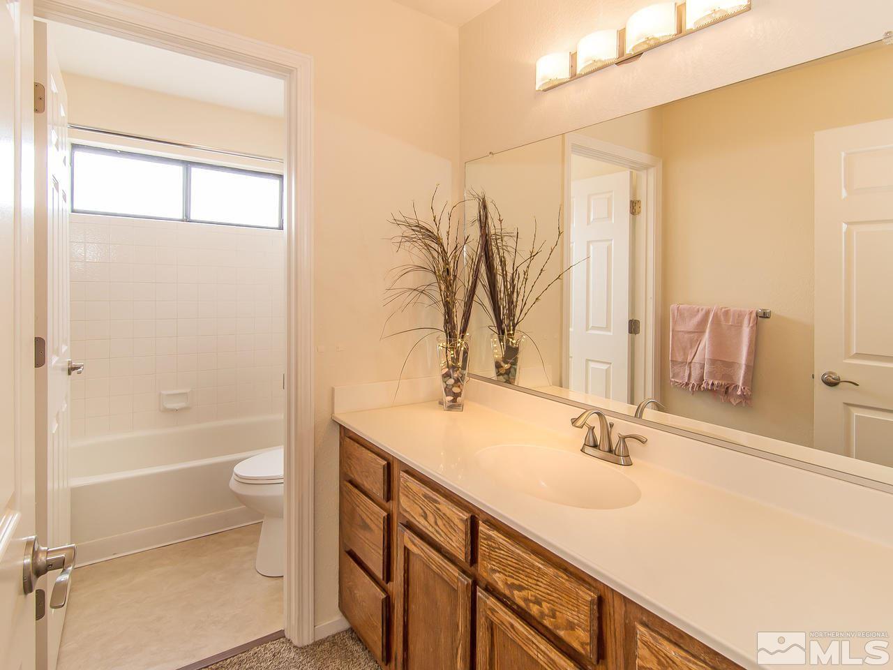 5302 Vista Ridge Way Reno, NV 89523 - Photo 17 of 20 a bathroom with a sink and a mirror
