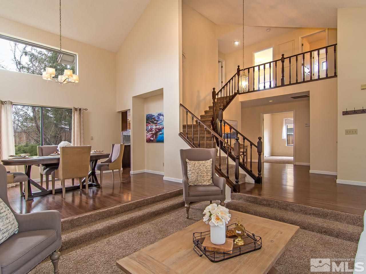 5302 Vista Ridge Way Reno, NV 89523 - Photo 4 of 20 a living room with couches chairs and a dining table with wooden floor