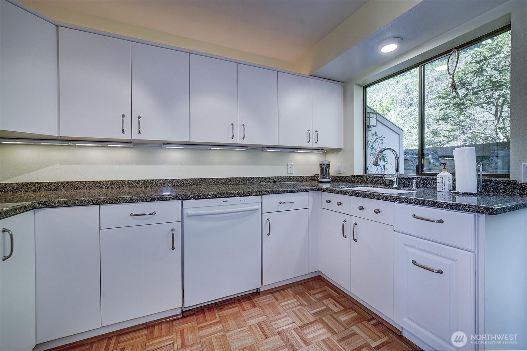 3142 Sahali Drive Bremerton, WA 98310 - Photo 8 of 23 a kitchen with granite countertop white cabinets stainless steel appliances a sink and large window
