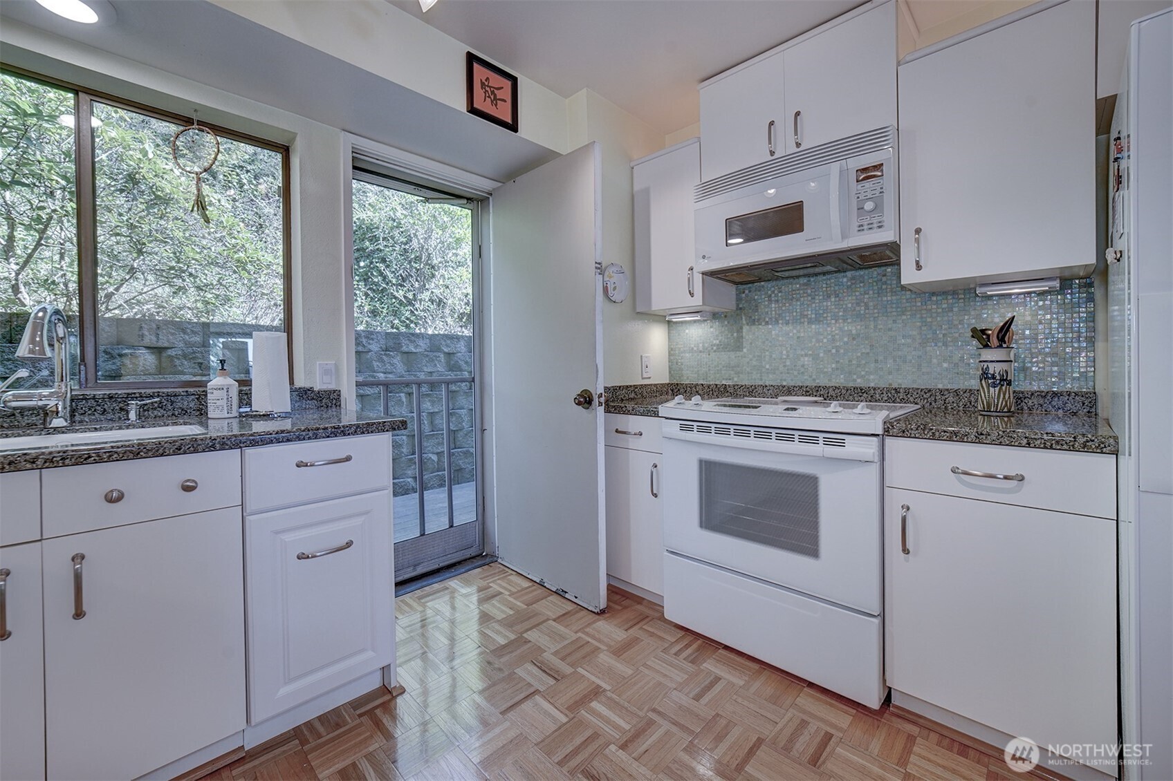 3142 Sahali Drive Bremerton, WA 98310 - Photo 9 of 23 a kitchen with stainless steel appliances granite countertop white cabinets and a window