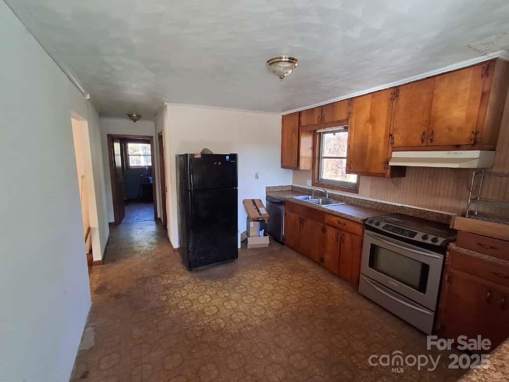 8092 Riverview Road Norwood, NC 28128 - Photo 12 of 45 a kitchen with stainless steel appliances granite countertop a stove a sink and a refrigerator