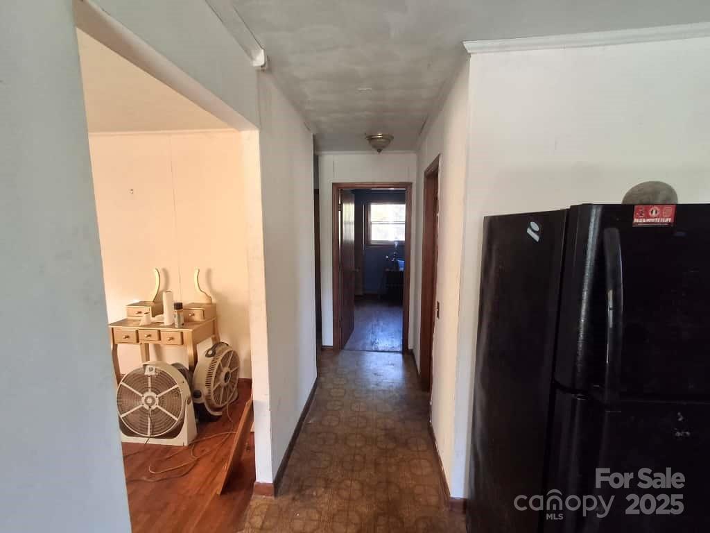 8092 Riverview Road Norwood, NC 28128 - Photo 14 of 45 a view of a hallway with wooden floor and a window