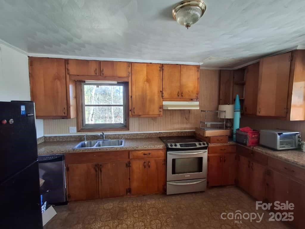 8092 Riverview Road Norwood, NC 28128 - Photo 20 of 45 a kitchen with stainless steel appliances granite countertop a stove a sink and a microwave