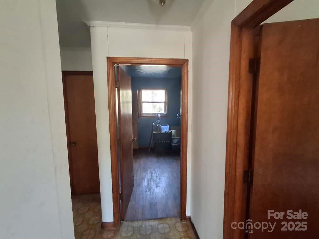 8092 Riverview Road Norwood, NC 28128 - Photo 32 of 45 a view of a hallway with wooden floor a living room