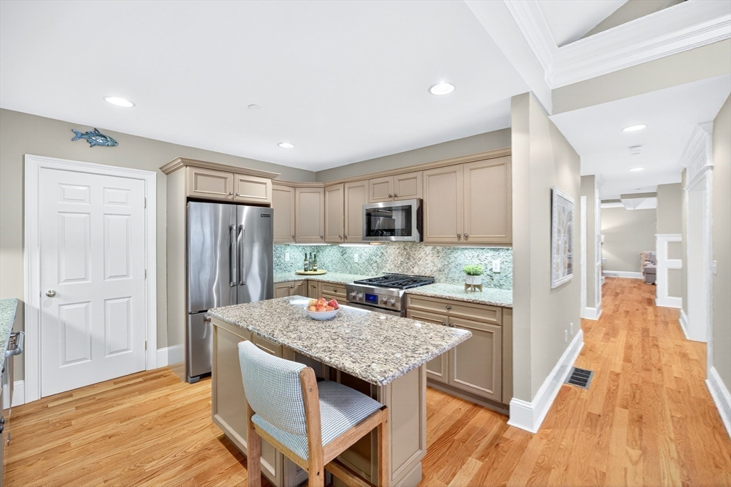 199 East Bay Road, Unit 13 Barnstable, MA 02655 - Photo 17 of 40 a kitchen with a table and chairs in it