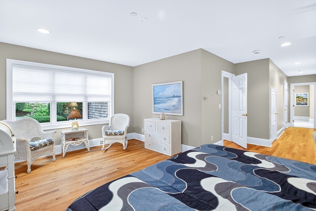 199 East Bay Road, Unit 13 Barnstable, MA 02655 - Photo 19 of 40 a bedroom with a bed and wooden floor