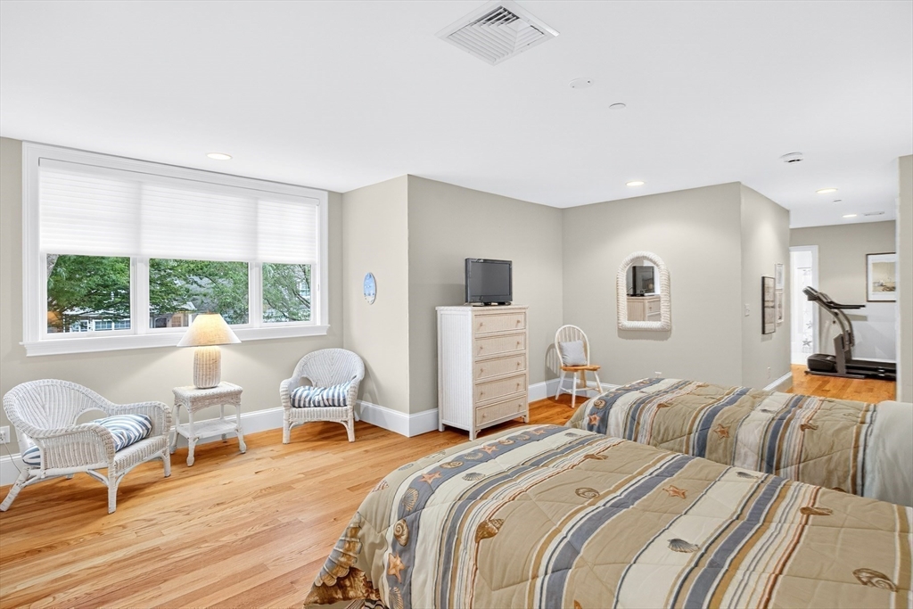199 East Bay Road, Unit 13 Barnstable, MA 02655 - Photo 23 of 40 a bed room with two beds and a chair
