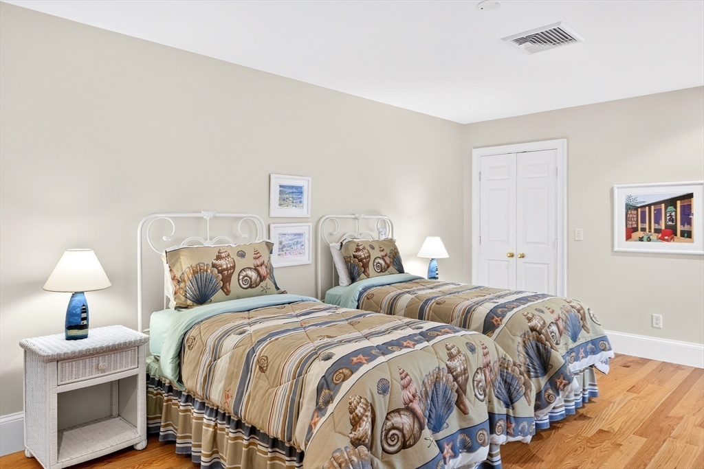 199 East Bay Road, Unit 13 Barnstable, MA 02655 - Photo 24 of 40 a bedroom with two beds and a lamp