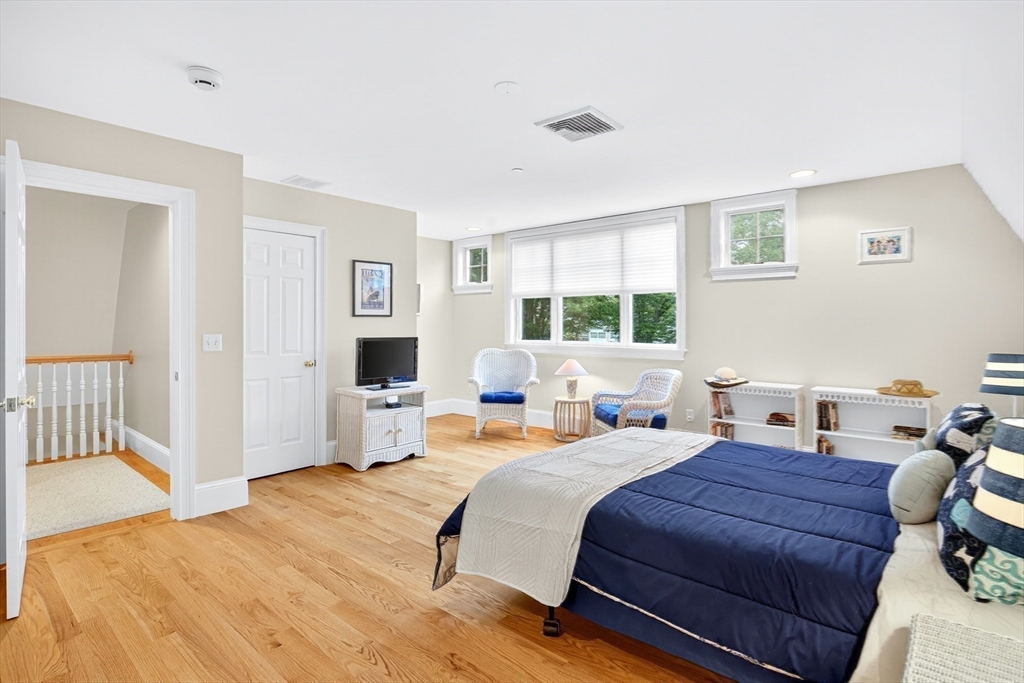 199 East Bay Road, Unit 13 Barnstable, MA 02655 - Photo 27 of 40 a bedroom with a bed and wooden floor